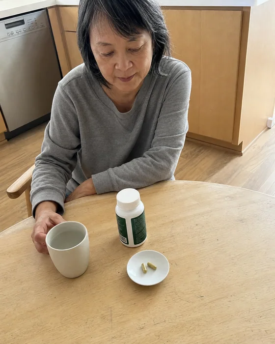 Woman sitting at a table with Citrus Bergamot and coffee
